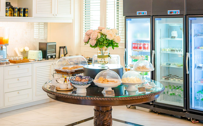 Buffet spread at The Coral Executive Lounge, Bangkok Airport, featuring pastries and beverages.