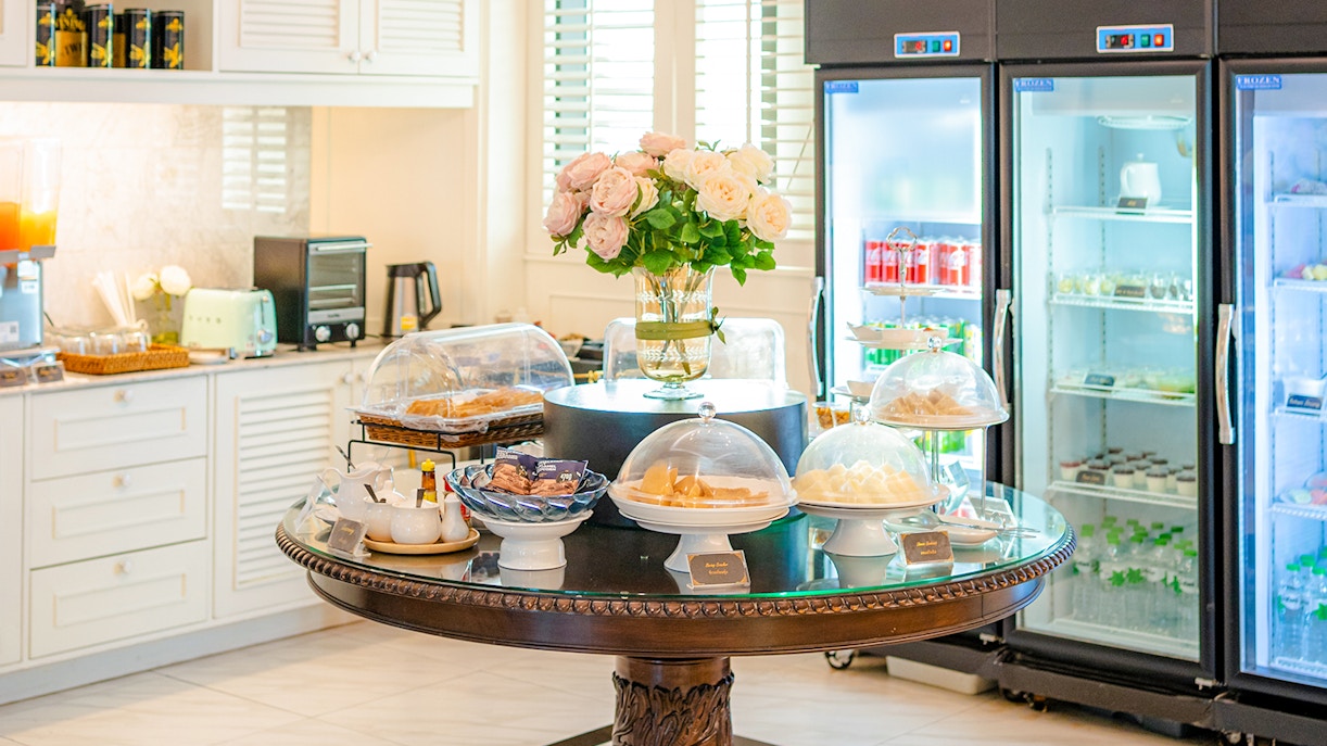 Buffet spread at The Coral Executive Lounge, Bangkok Airport, featuring pastries and beverages.