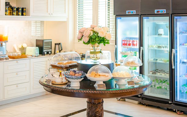 Buffet spread at The Coral Executive Lounge, Bangkok Airport, featuring pastries and beverages.