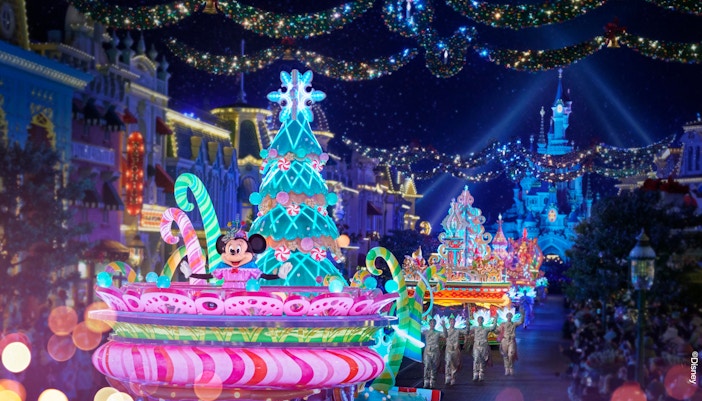 Disneyland Paris Electrical Sky Parade with illuminated floats and characters at night.