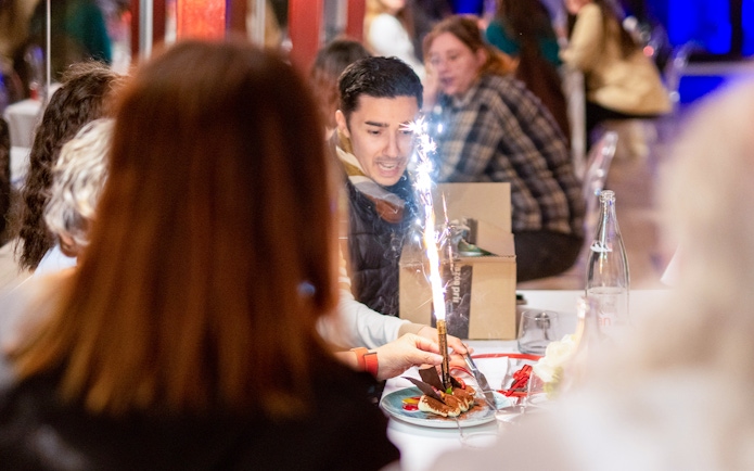 Guests enjoying dessert with sparklers on a Paris boat brunch cruise.