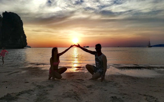 Couple enjoying sunset on Krabi beach during 4 Islands speedboat tour.