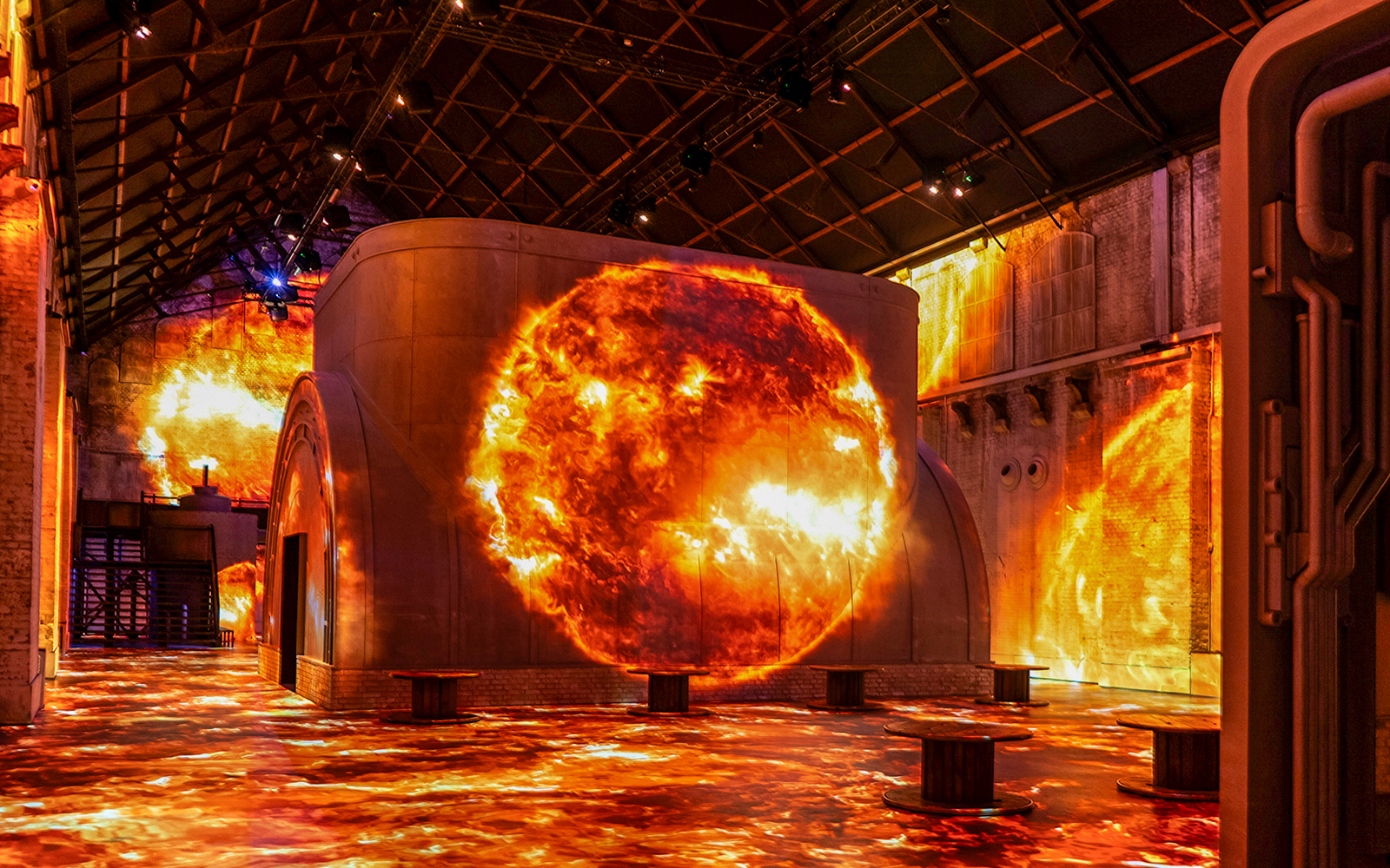 Fabrique des Lumières exhibit with cosmic projections on walls and floor.