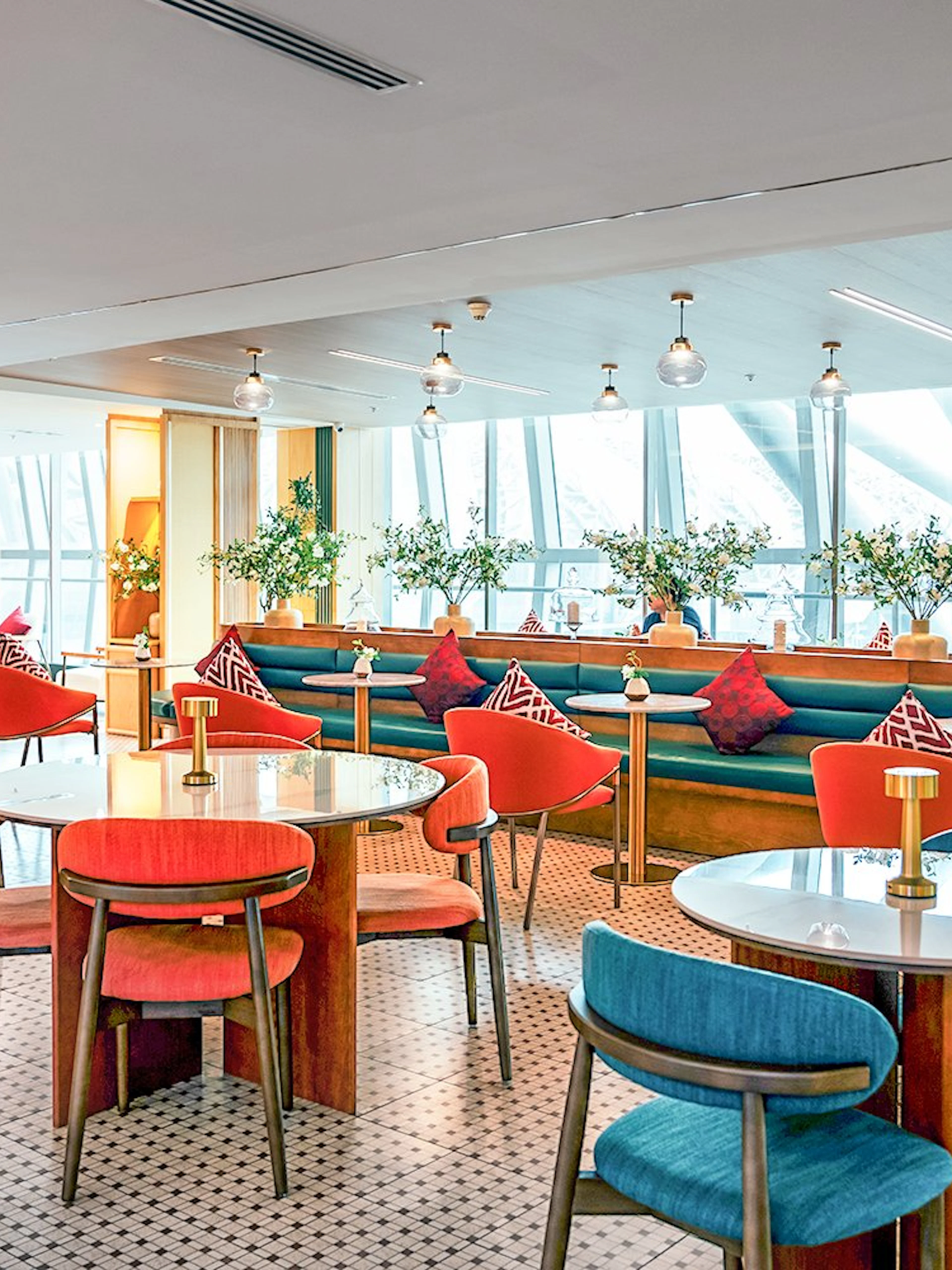 Coral Airport Lounge seating area at Suvarnabhumi Airport with tables and chairs.