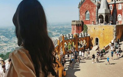 Visitors exploring Pena Palace courtyard on a private half-day Sintra tour from Lisbon.