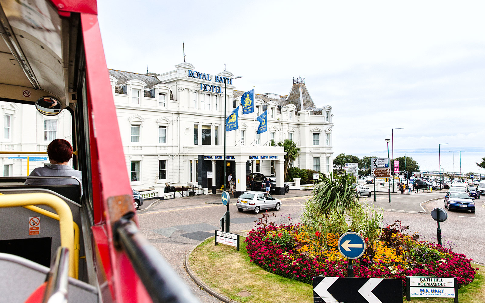 Visitors on Bournemouth Hop on Hop off bus viewing Royal Bath Hotel.