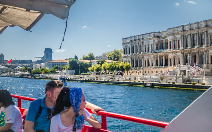 Guests viewing Çırağan Palace from Bosphorus cruise in Istanbul.