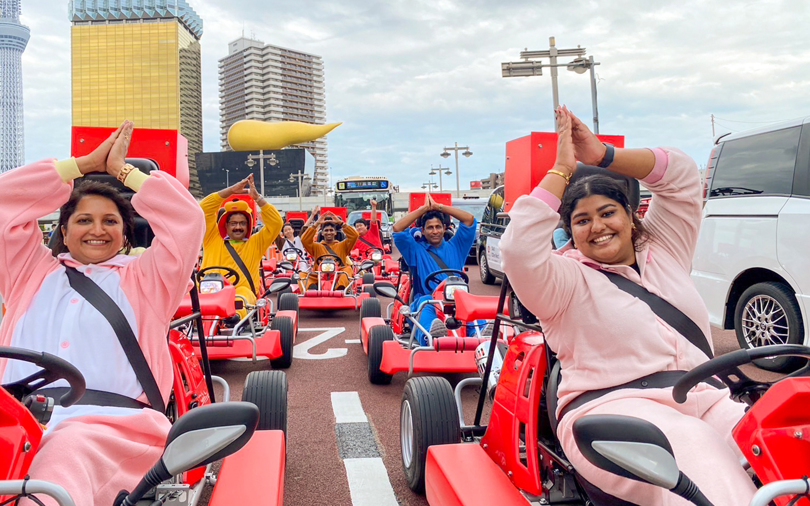 Participants in costumes driving go-karts on Osaka Namba street during 1-hour tour.