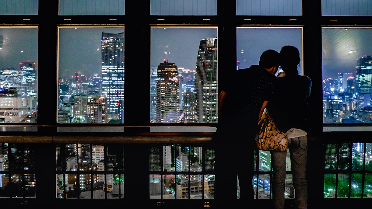 Couple looking at the view at night from Tokyo Tower, Tokyo