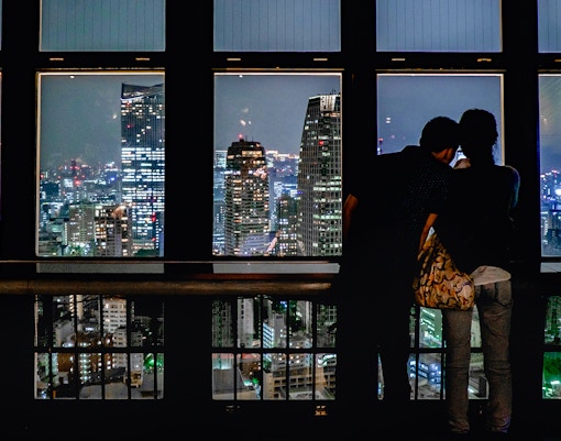 Couple looking at the view at night from Tokyo Tower, Tokyo