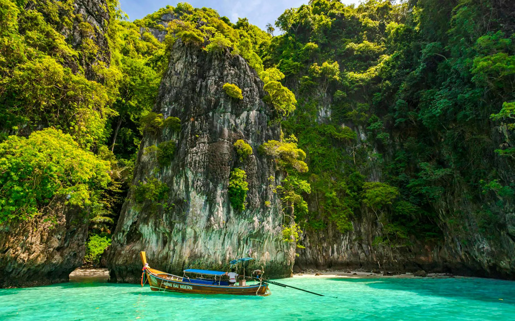 Catamaran near limestone cliffs and turquoise water, Phi Phi Islands, Phuket tour.