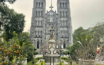 St. Joseph's Cathedral facade with garden, Hanoi Old Quarter exploration game.