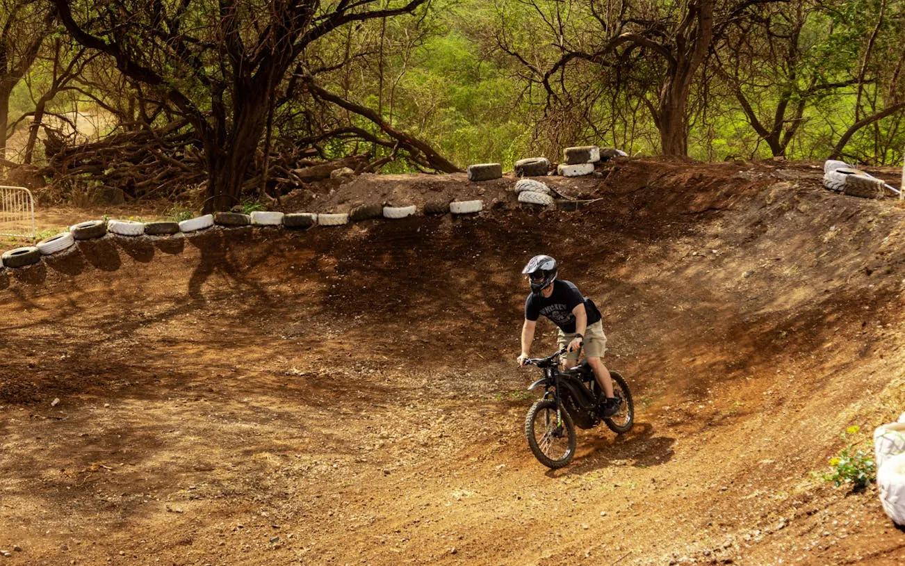 Dirt biker navigating a track in Oahu with expert guidance.