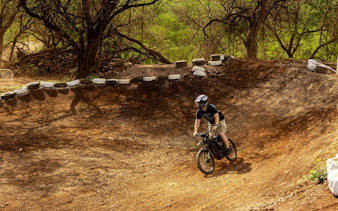 Dirt biker navigating a track in Oahu with expert guidance.