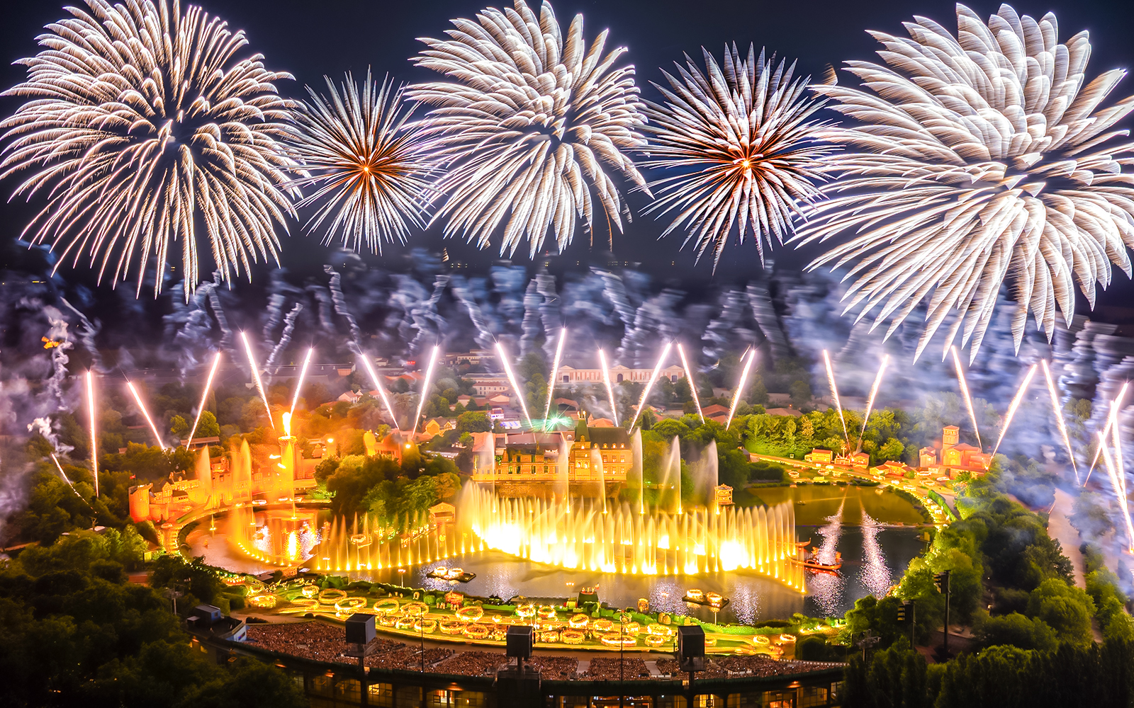 Fireworks display over Puy du Fou theme park in France during a night light show.