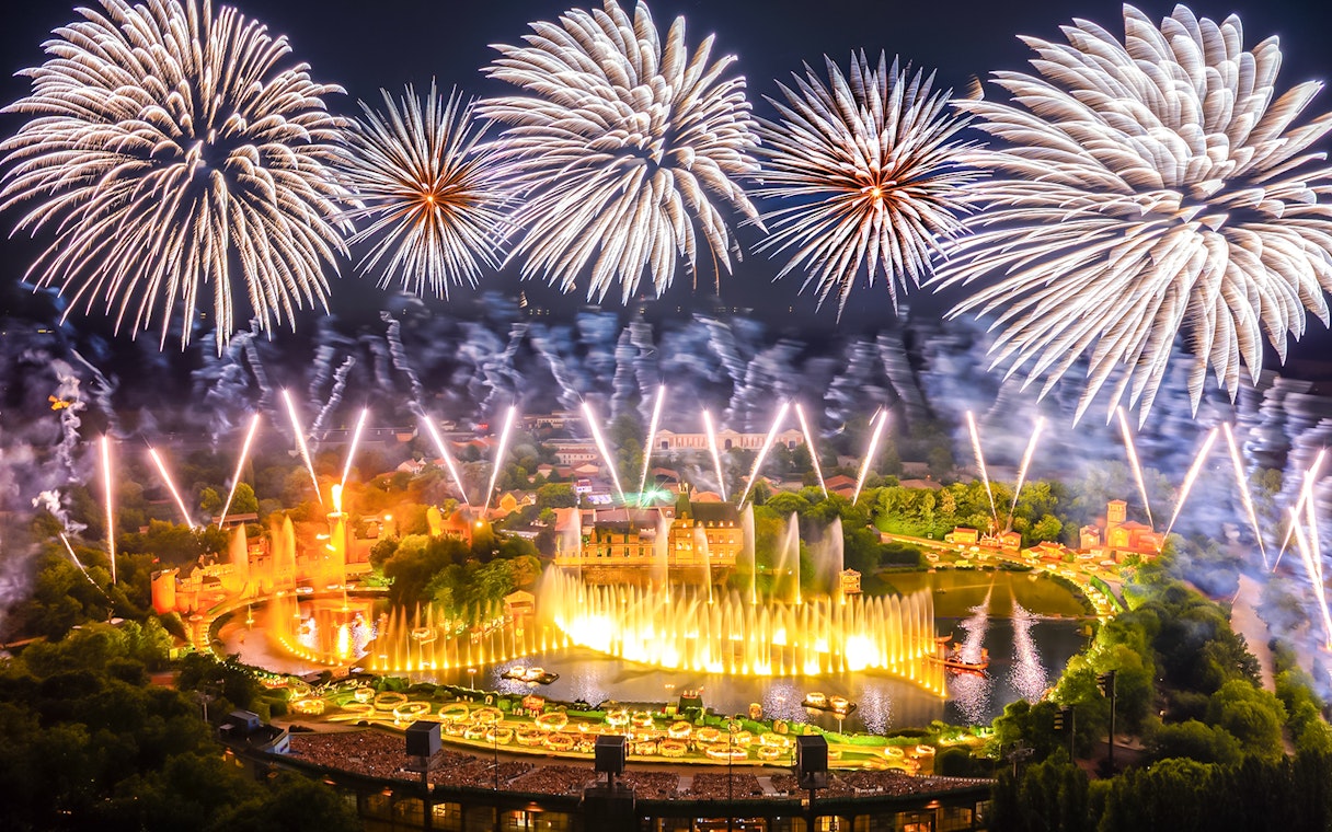 Fireworks display over Puy du Fou theme park in France during a night light show.