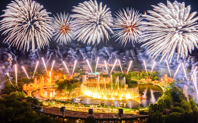 Fireworks display over Puy du Fou theme park in France during a night light show.