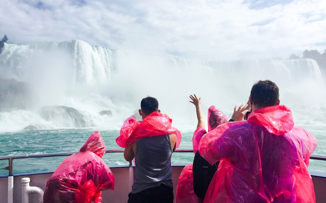 Visitors in red ponchos on a boat near Niagara Falls, Canada.