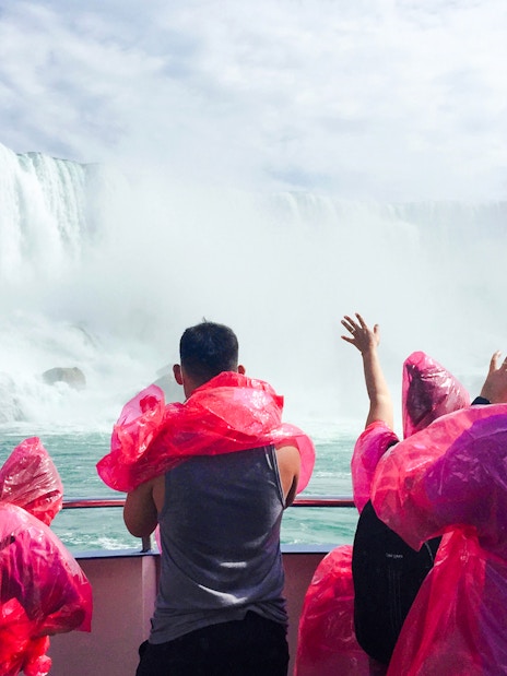 Visitors in red ponchos on a boat near Niagara Falls, Canada.