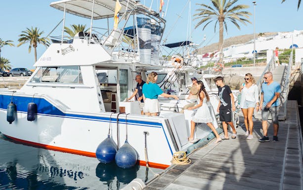 Tourists boarding a boat for a dolphin and whale watching cruise in Gran Canaria.