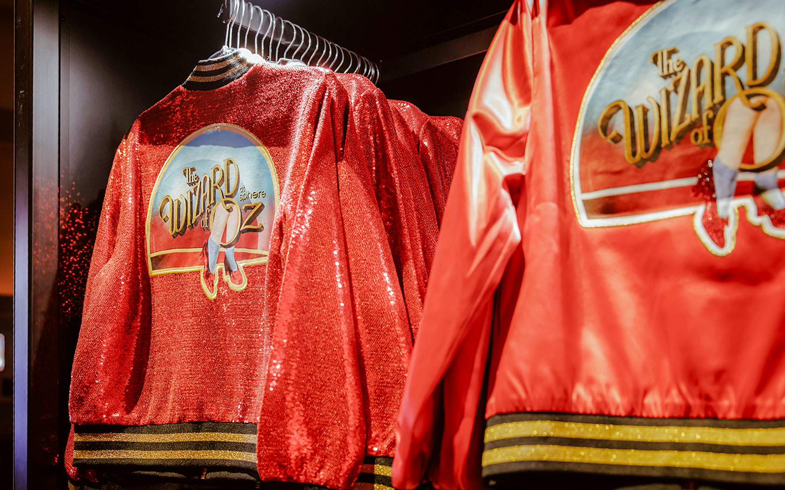 Red jackets with "Wizard of Oz at Sphere" logo on display.