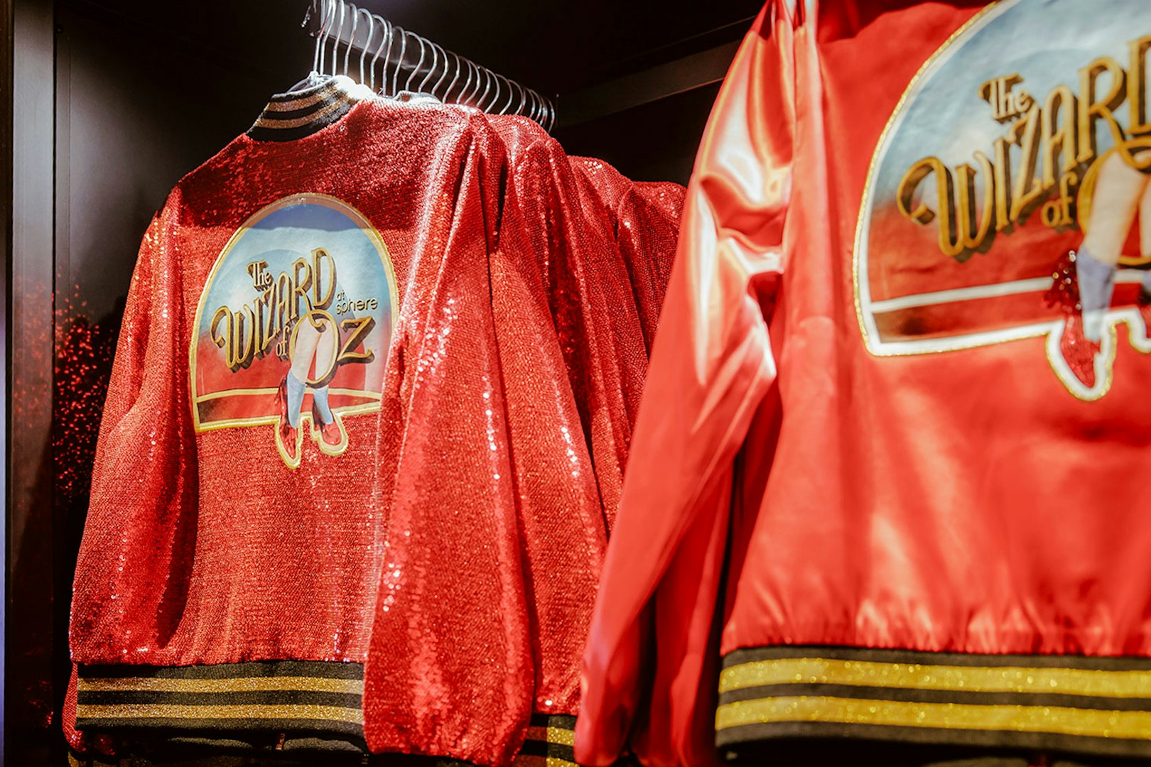 Red jackets with "Wizard of Oz at Sphere" logo on display.