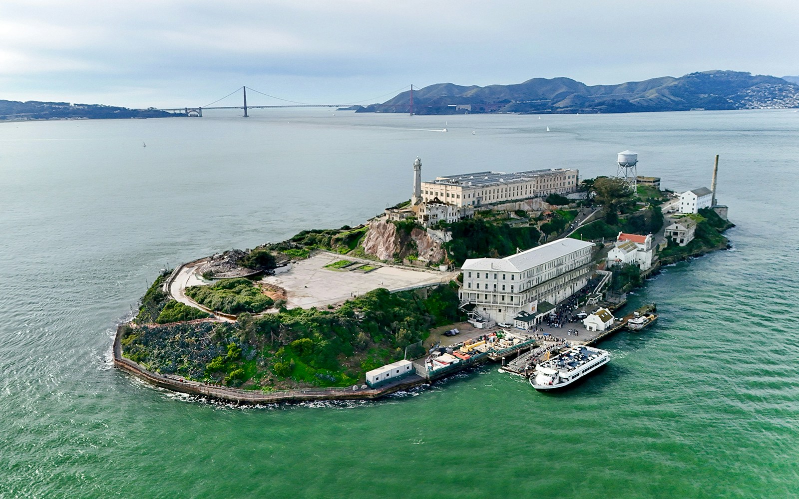 Aerial view of Alcatraz Island with San Francisco skyline in the background.