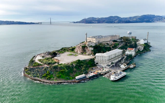 Aerial view of Alcatraz Island with San Francisco skyline in the background.