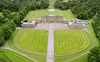 Hopetoun House aerial view, featured in Outlander, surrounded by lush greenery near Edinburgh.