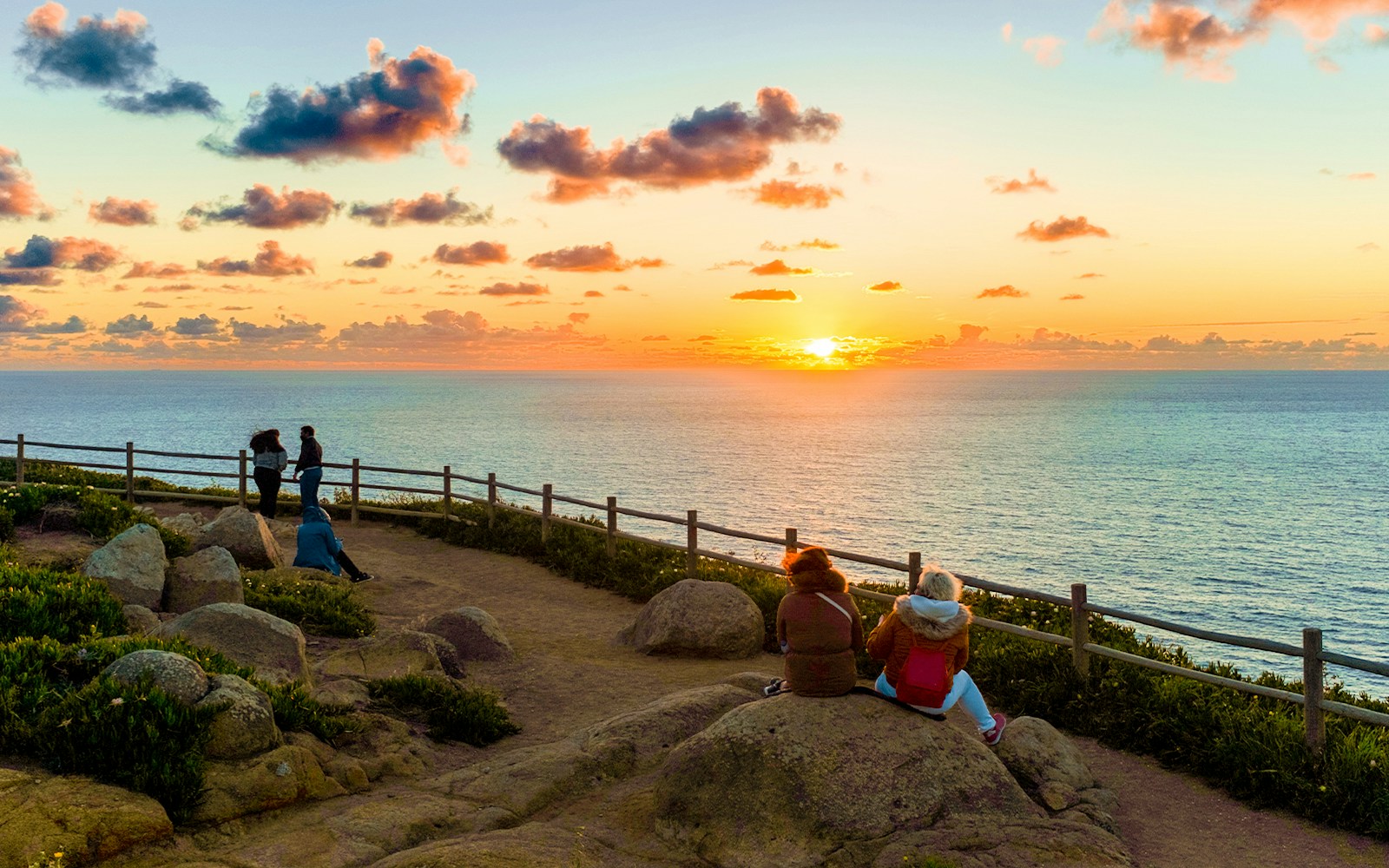 People enjoying sunset views at Cabo da Roca, Sintra, Portugal.