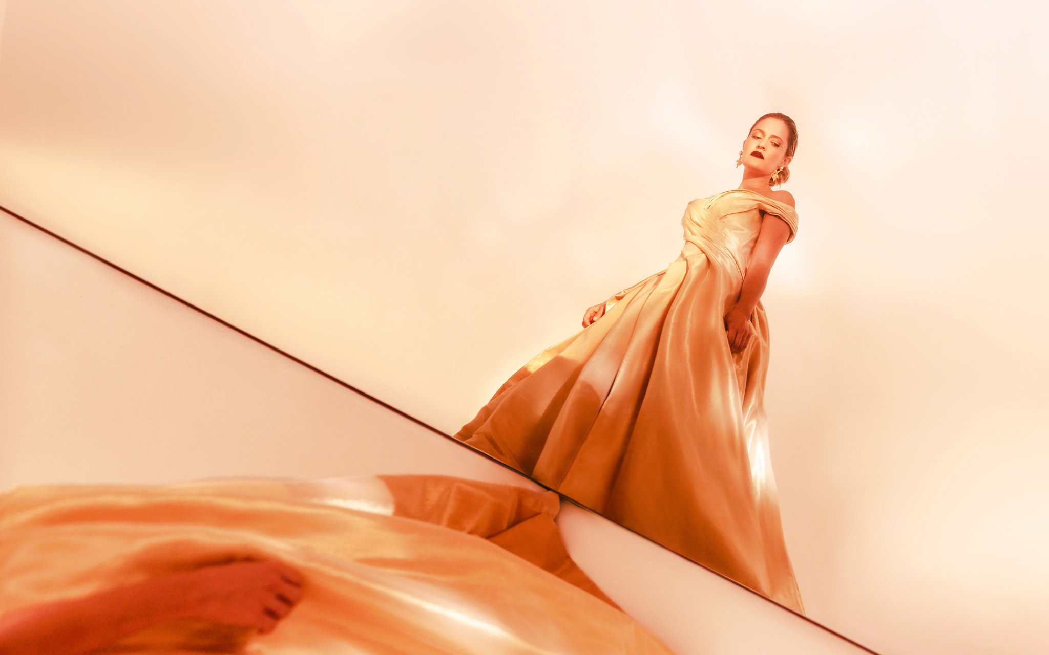 Opera singer in elegant gown performing in La Traviata production.