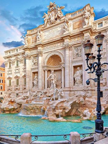 Trevi Fountain in Rome with ornate sculptures and flowing water.