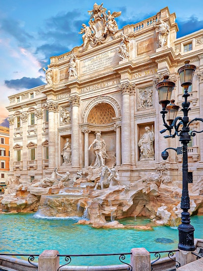 Trevi Fountain in Rome with ornate sculptures and flowing water.