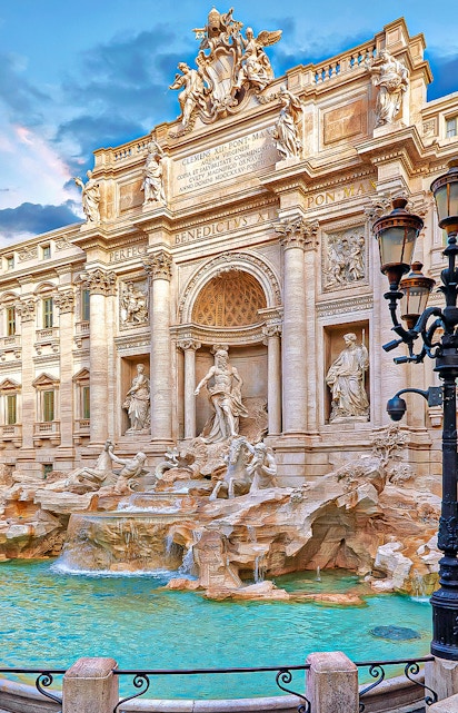 Trevi Fountain in Rome with ornate sculptures and flowing water.