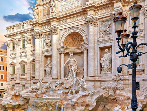 Trevi Fountain in Rome with ornate sculptures and flowing water.