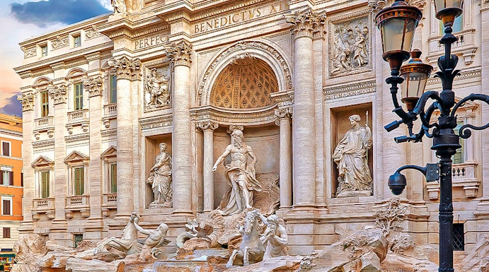 Trevi Fountain in Rome with ornate sculptures and flowing water.
