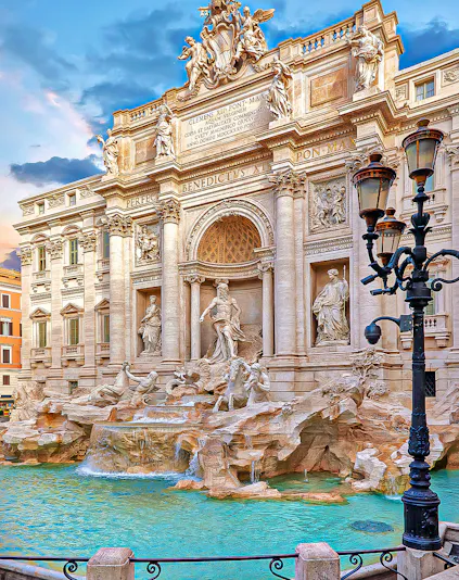 Trevi Fountain in Rome with ornate sculptures and flowing water.