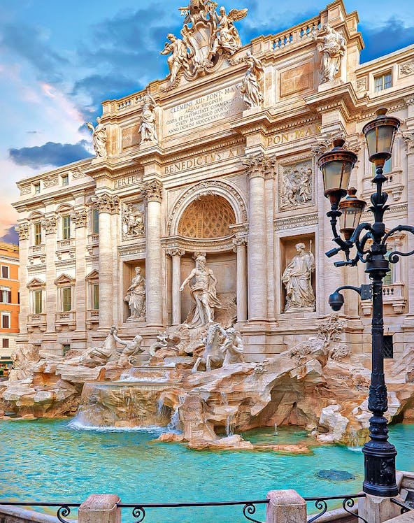 Trevi Fountain in Rome with ornate sculptures and flowing water.