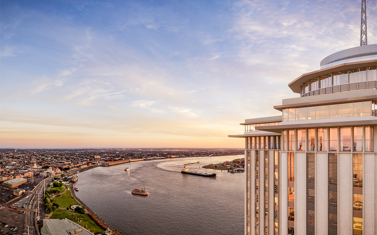 Aerial view of the Vue Orleans Observation Deck overlooking the Mississippi River at sunset.
