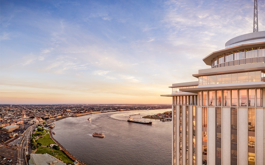 Aerial view of the Vue Orleans Observation Deck overlooking the Mississippi River at sunset.