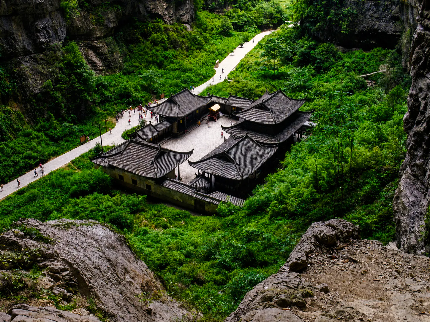 Ancient Chinese architecture surrounded by lush greenery in Chongqing.