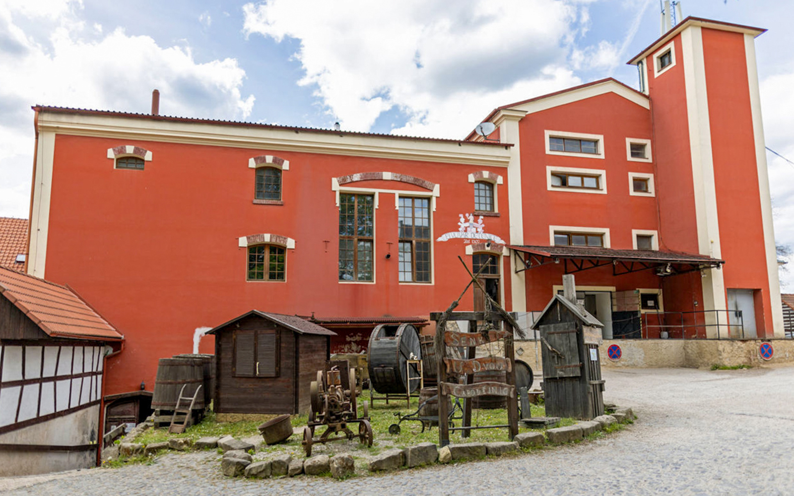 Baroque castle exterior with red facade and historical artifacts, Prague.