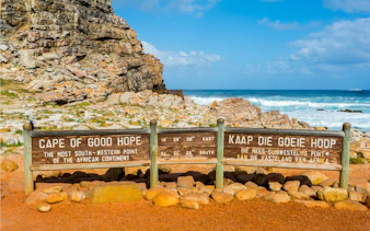 Cape of Good Hope sign with ocean and rocky landscape, Cape Town, South Africa.