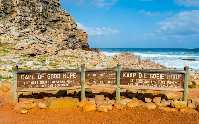 Cape of Good Hope sign with ocean and rocky landscape, Cape Town, South Africa.