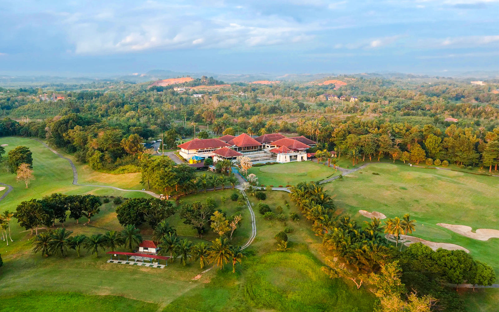 Aerial view of Batam Island Country Club surrounded by lush greenery and golf course.