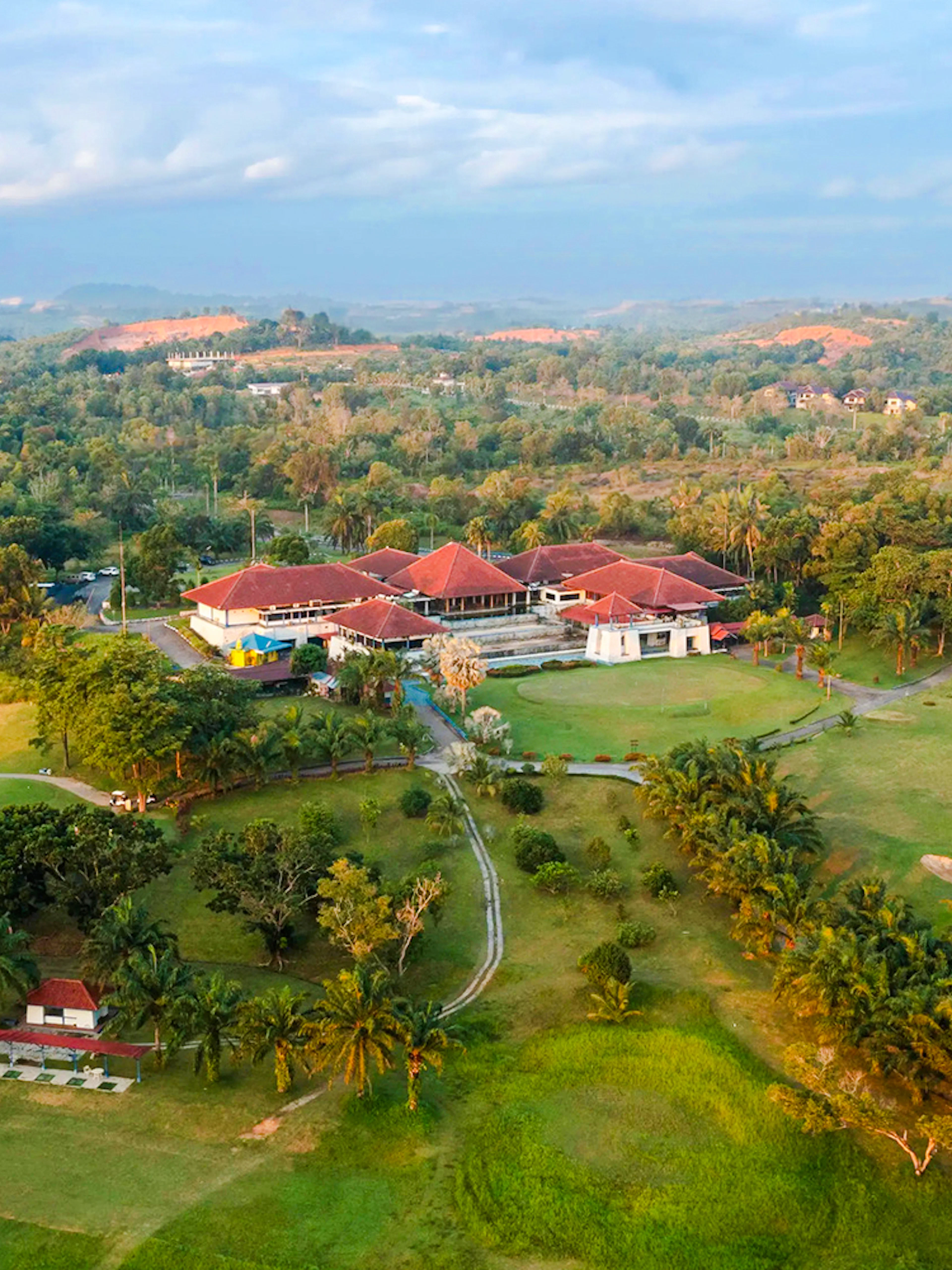 Aerial view of Batam Island Country Club surrounded by lush greenery and golf course.