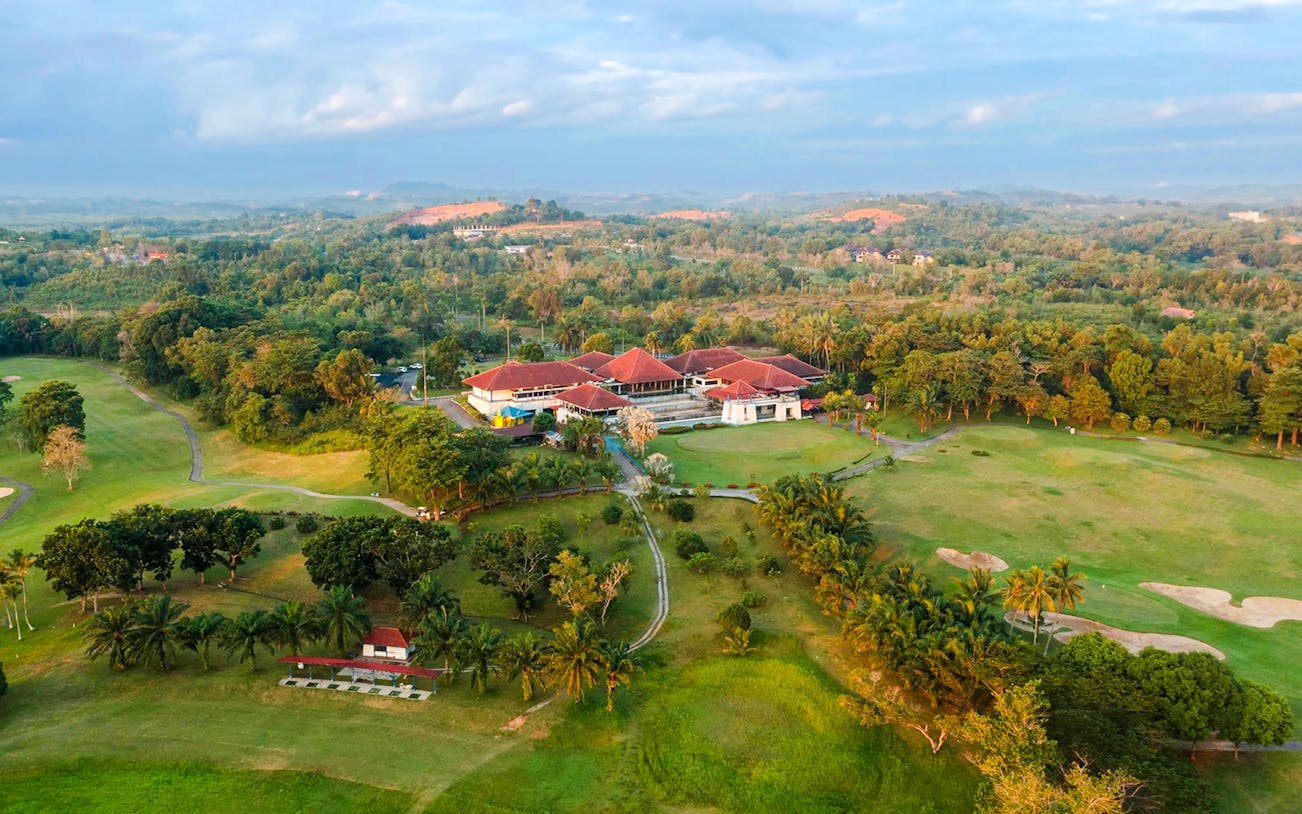 Aerial view of Batam Island Country Club surrounded by lush greenery and golf course.