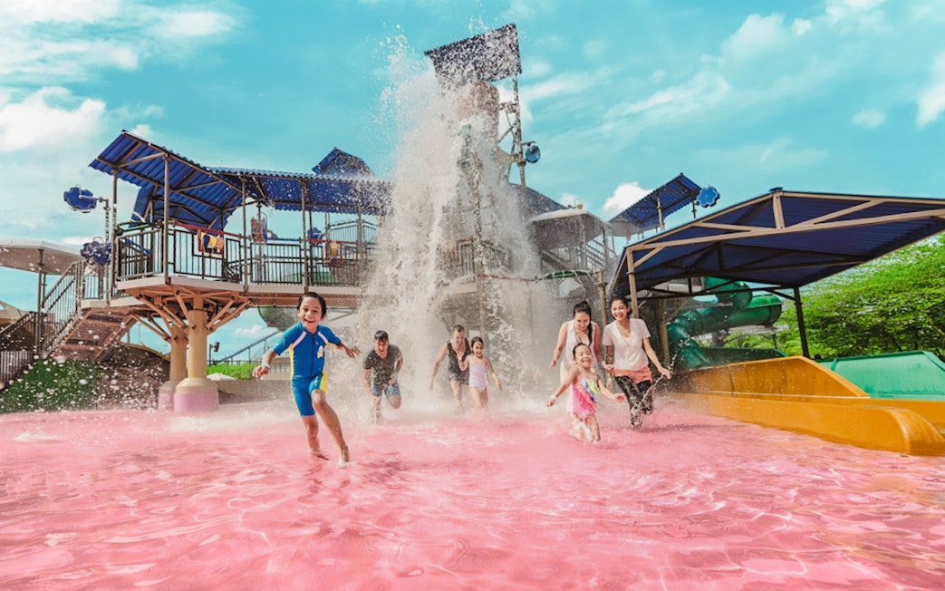 Tourists enjoying pink water pool at Adventure Waterpark Desaru Coast.
