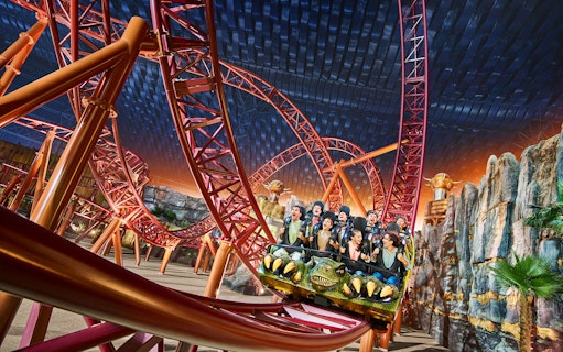 Roller coaster ride at IMG World of Adventure, Dubai, with excited passengers during Glitter Ball Party.