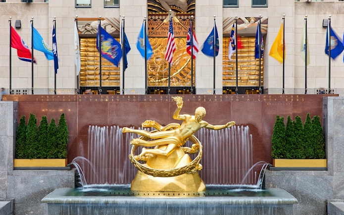 Prometheus statue and flags at Rockefeller Center, New York City.